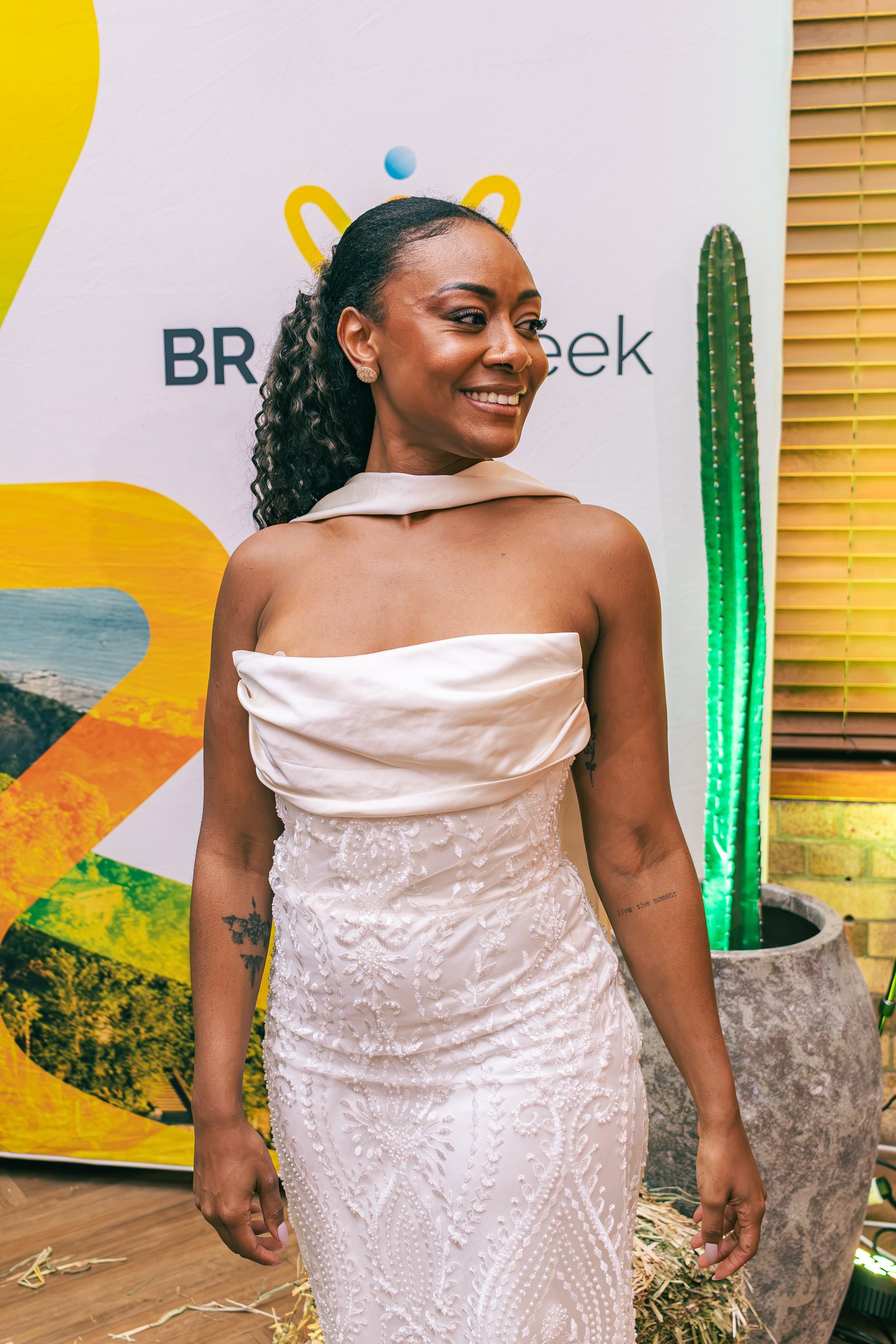 Smiling woman wearing a custom white beaded couture gown