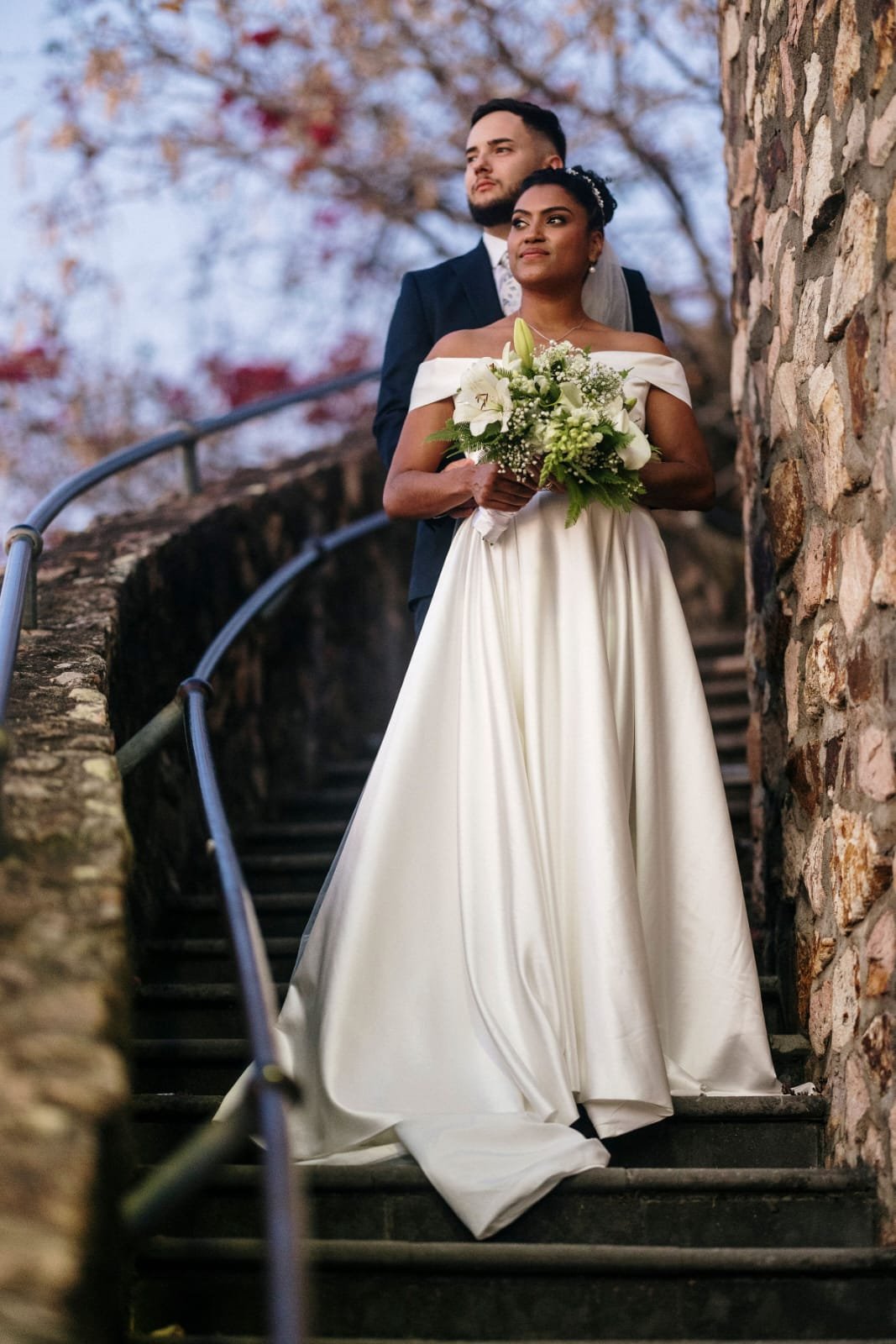 A silent fitting room with a gilded mirror and a single ivory gown